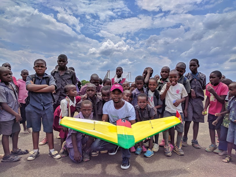 University student poses with school children at Kasungu Drone Corridor. 
