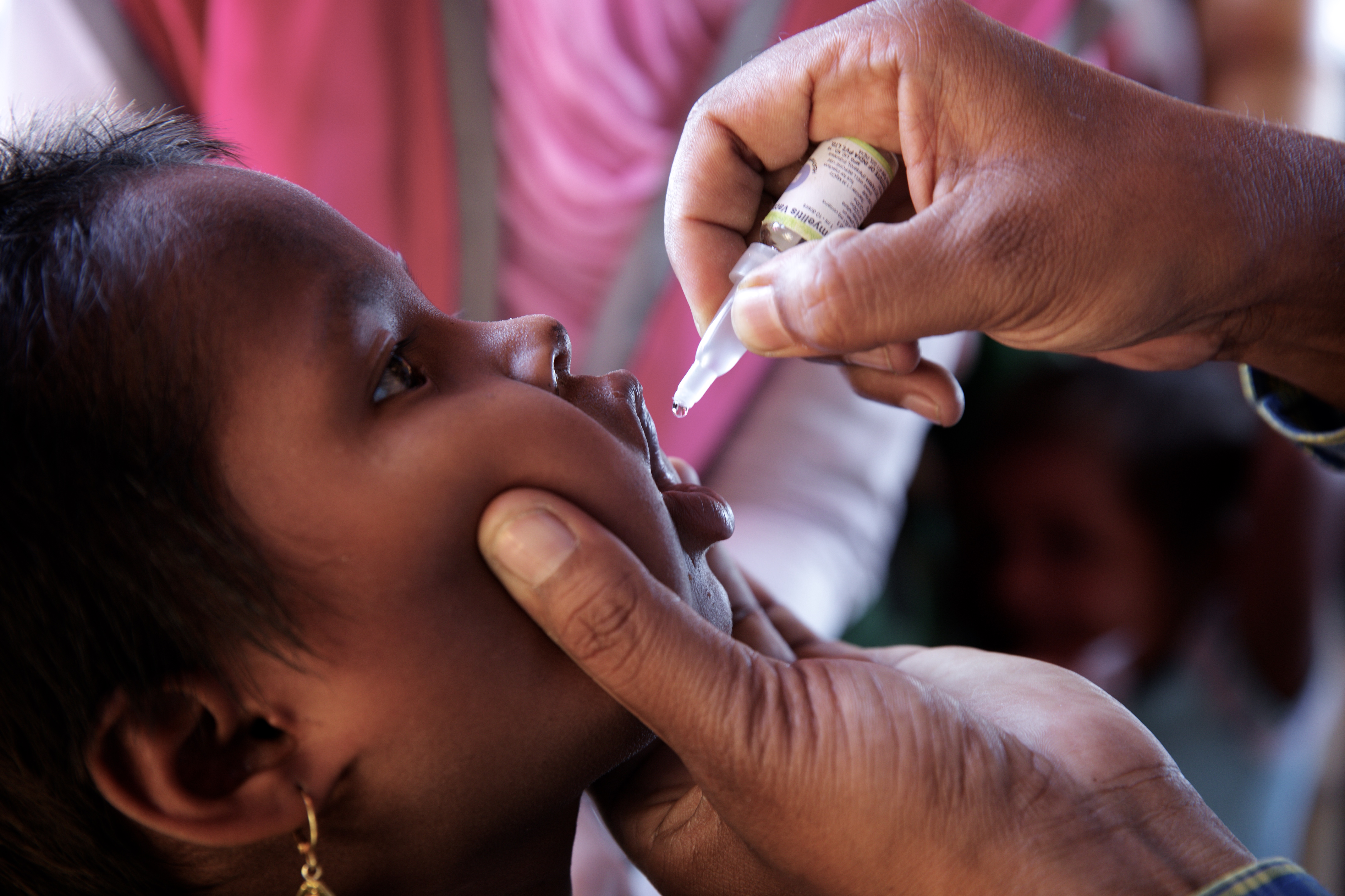A Rohingya refugee child is administered an oral polio vaccine at an immunization centre in Bormapara makeshift settlement, Cox's Bazar district, Bangladesh, Thursday 21 December 2017
