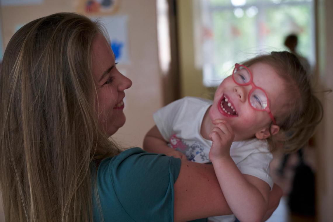 In Belarus, three-year-old Agatha laughs with her mother, Ekaterina, at home in Minsk, the capital. Agatha has cerebral palsy and other developmental disabilities.
