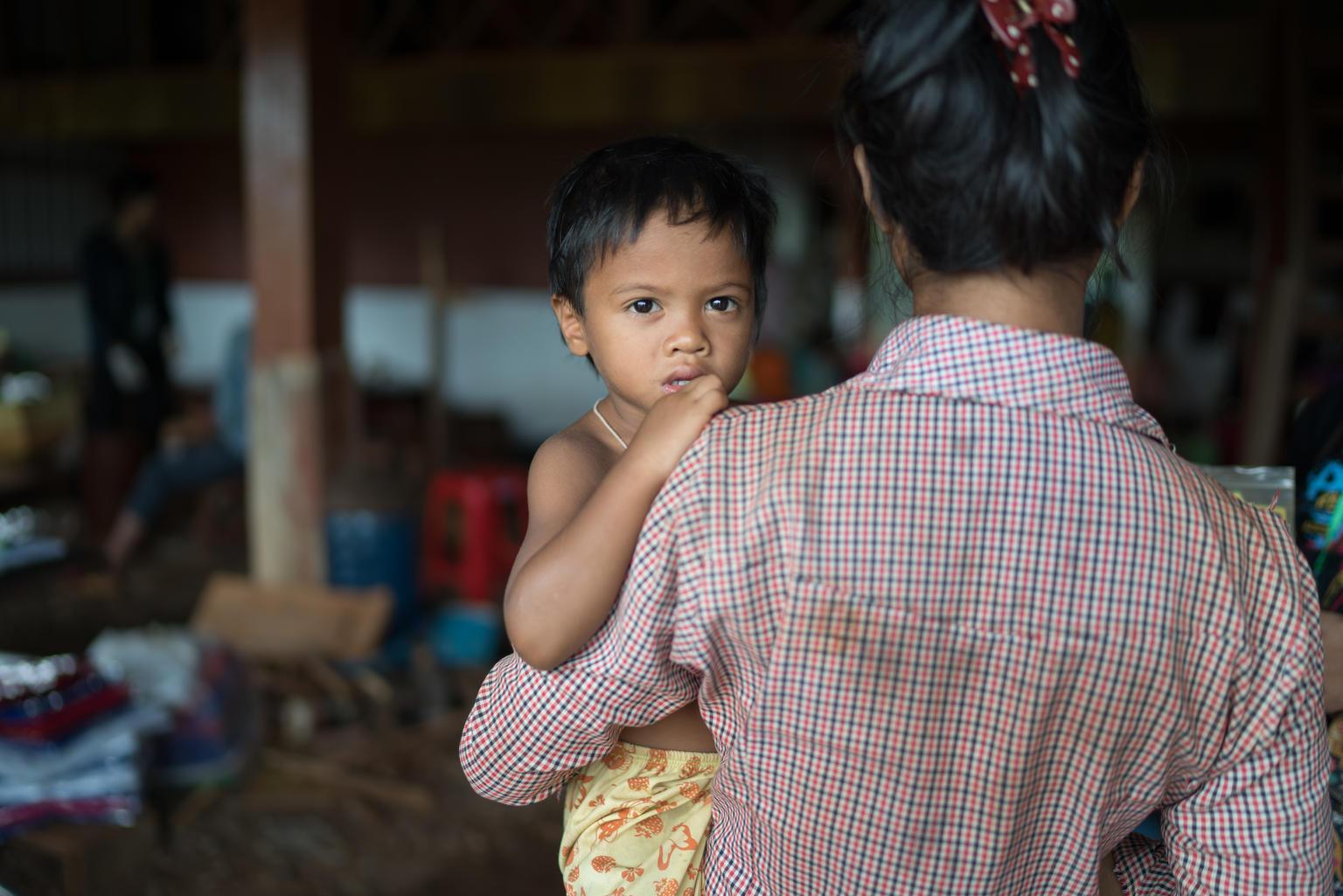 A child being held by a caretaker 