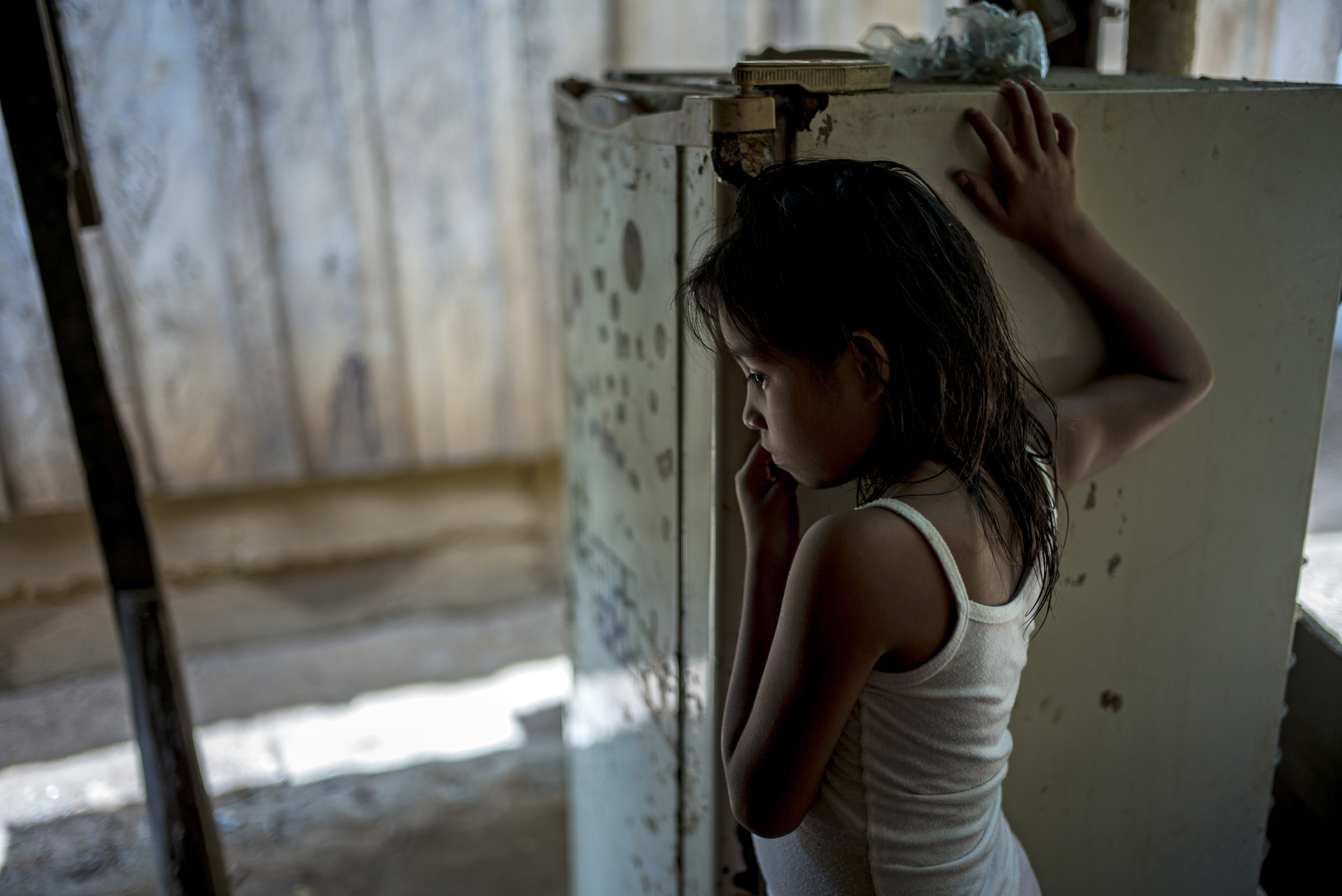 Yell, 8, Alexis' sister, in the family house in Omoa, Honduras on June 27th, 2016.