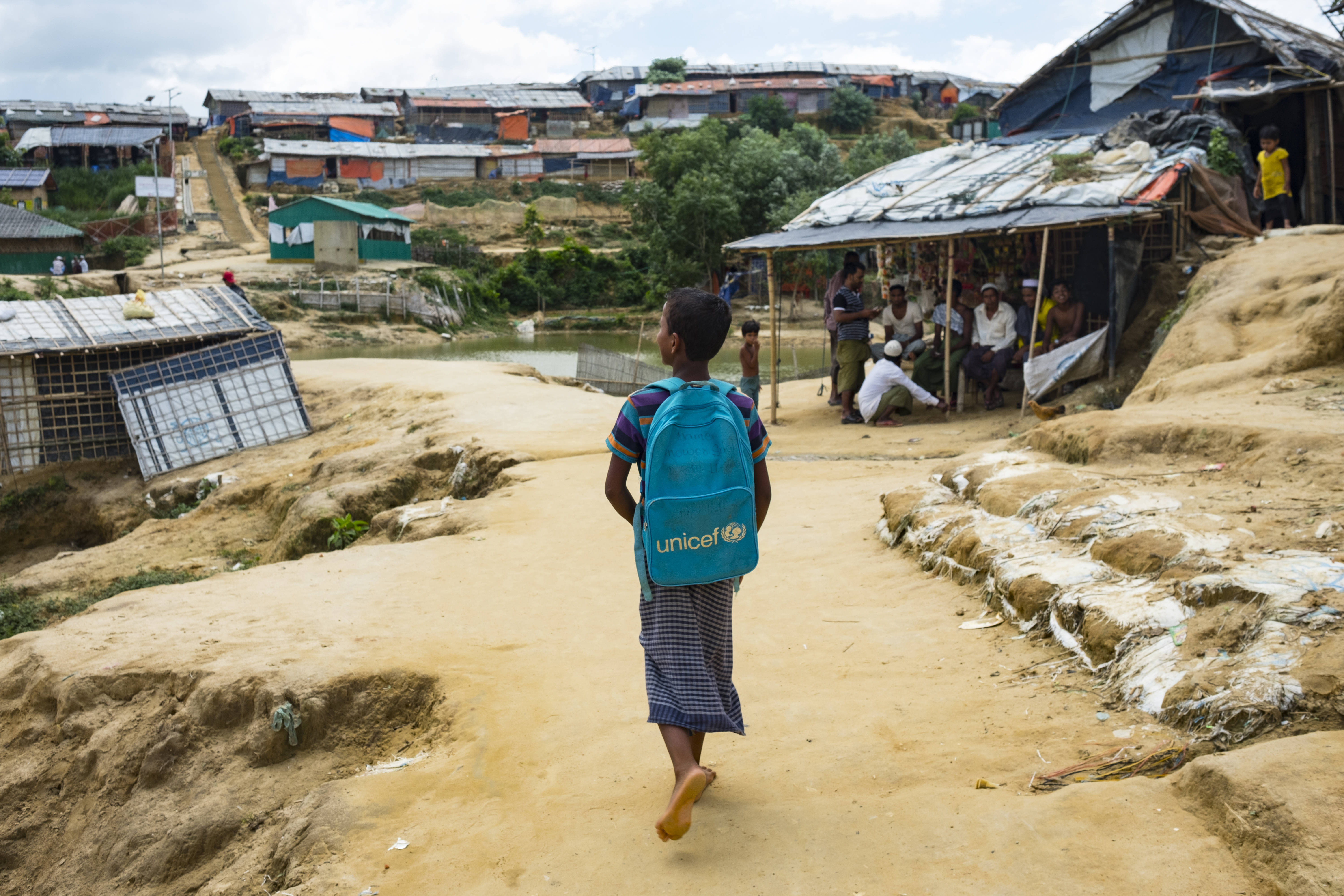 On 20 June 2019, a young student walks to a UNICEF learning centre in the Kutupalong refugee camp in Cox’s Bazar, Bangladesh.