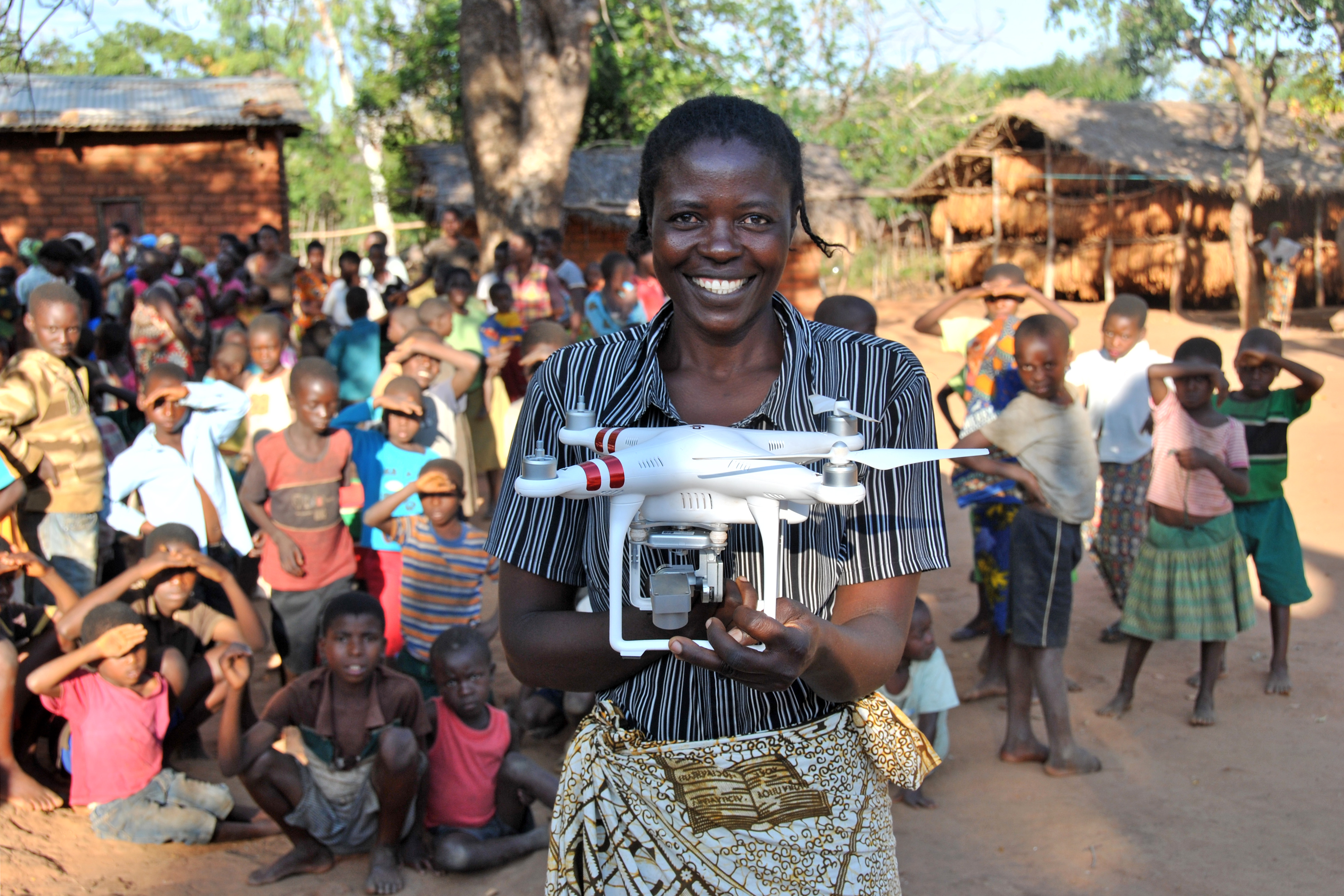 Resident Rhoda Nkhambule holds a drone following a public demonstration of the technology to residents in Thipa vllage, Kasungu District, Malawi, Thursday 29 June 2017.