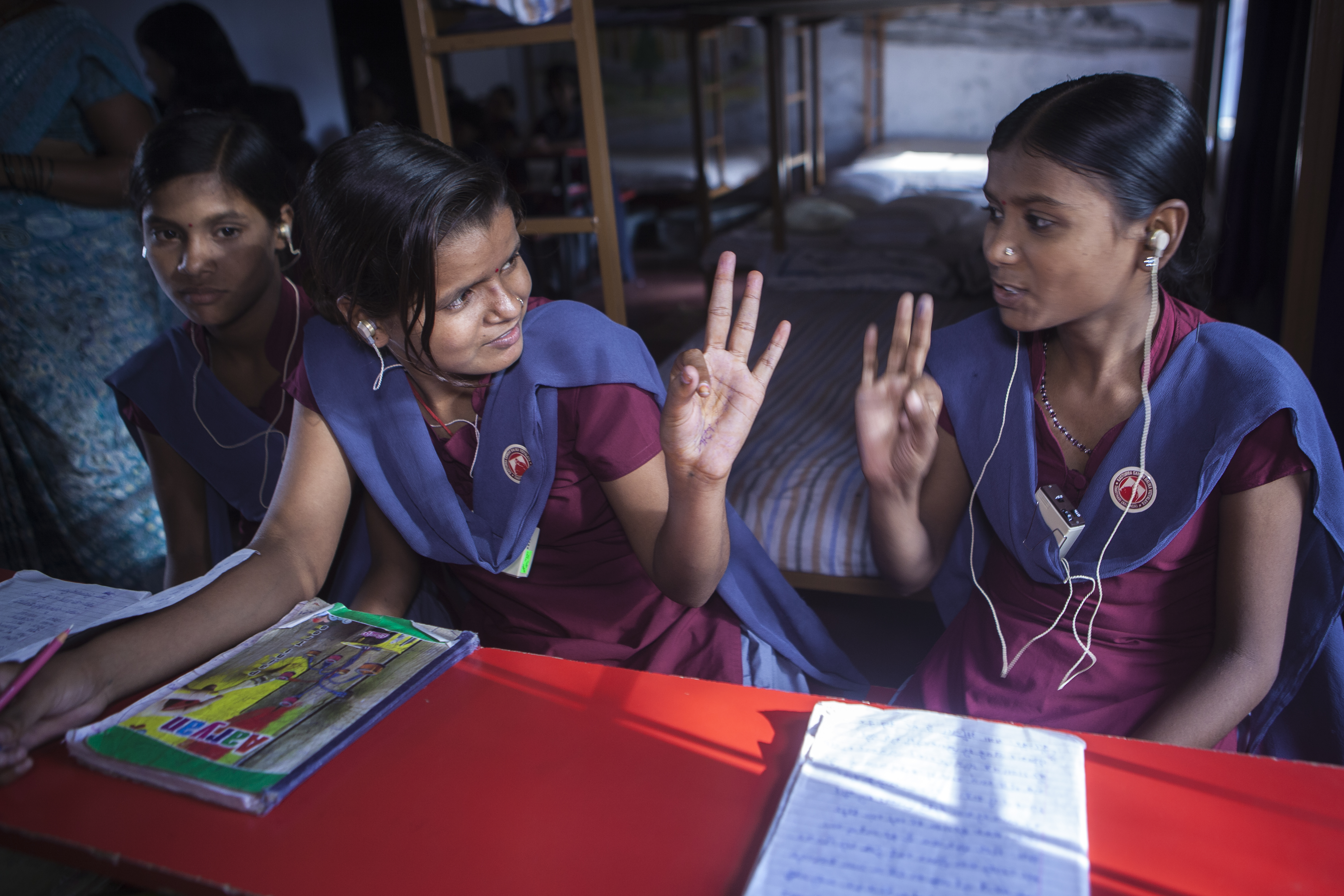 Sulekha (R), and Pratima (M) (hearing impaired) communicate during a class at a bridge school in ,KGBV ( Tharthari), May 17, 2013.