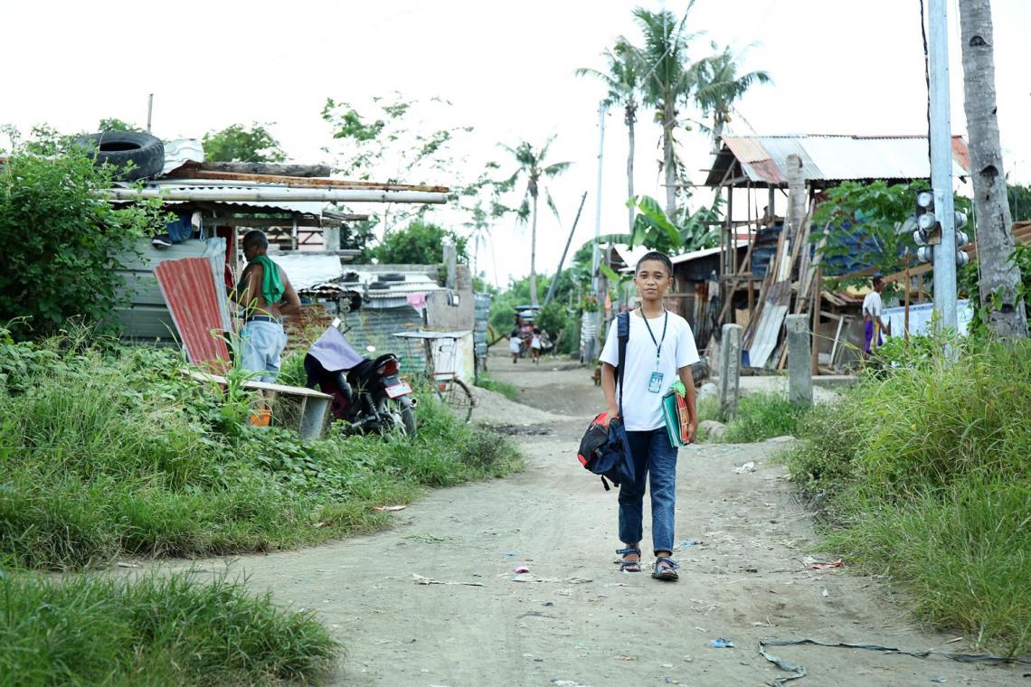 Edegario in his neighbourhood “Rainbow Village” after Typhoon Haiyan