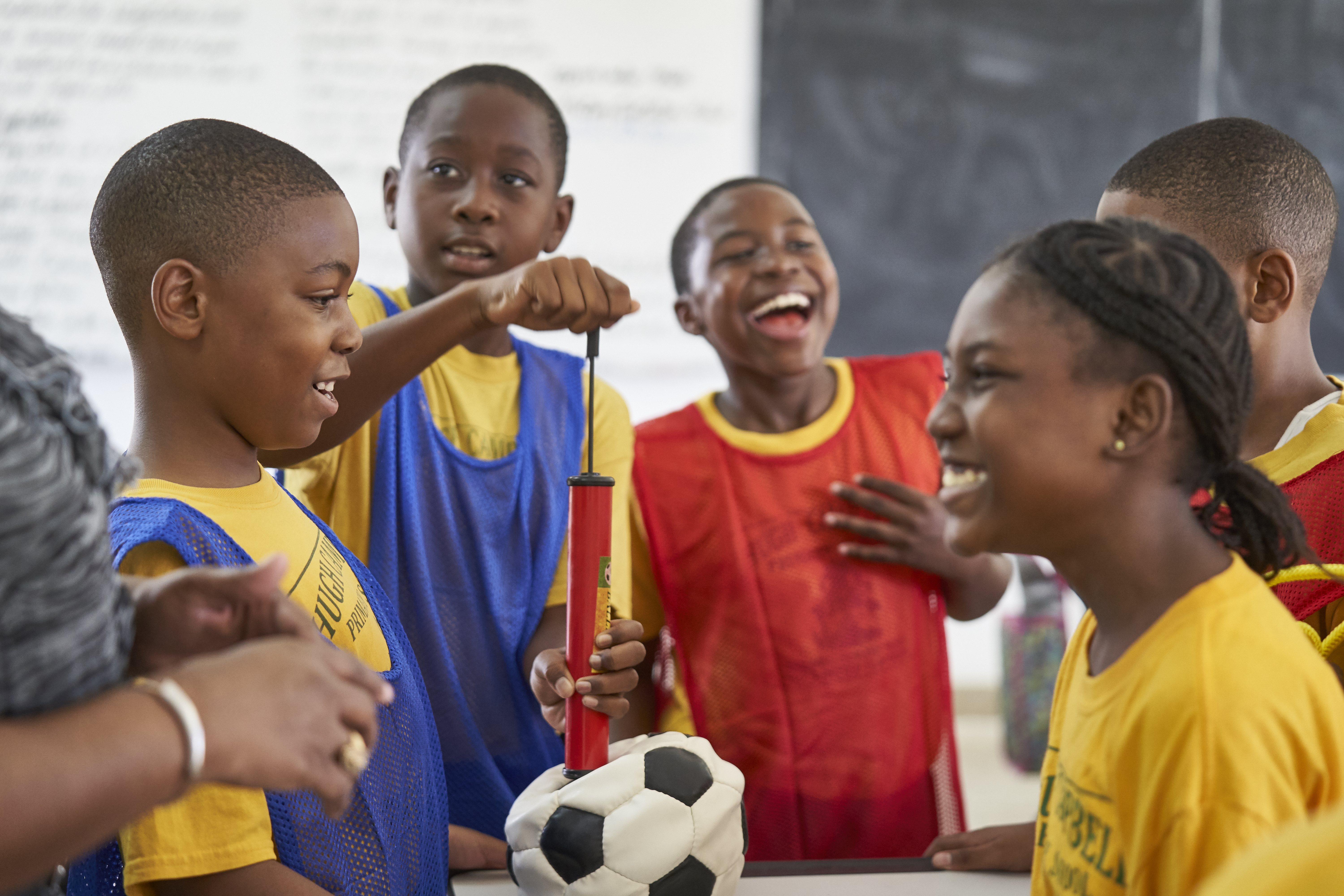 On 11 December in The Bahamas, children inflate a soccer ball, at Abaco Central Primary School in Abaco. 