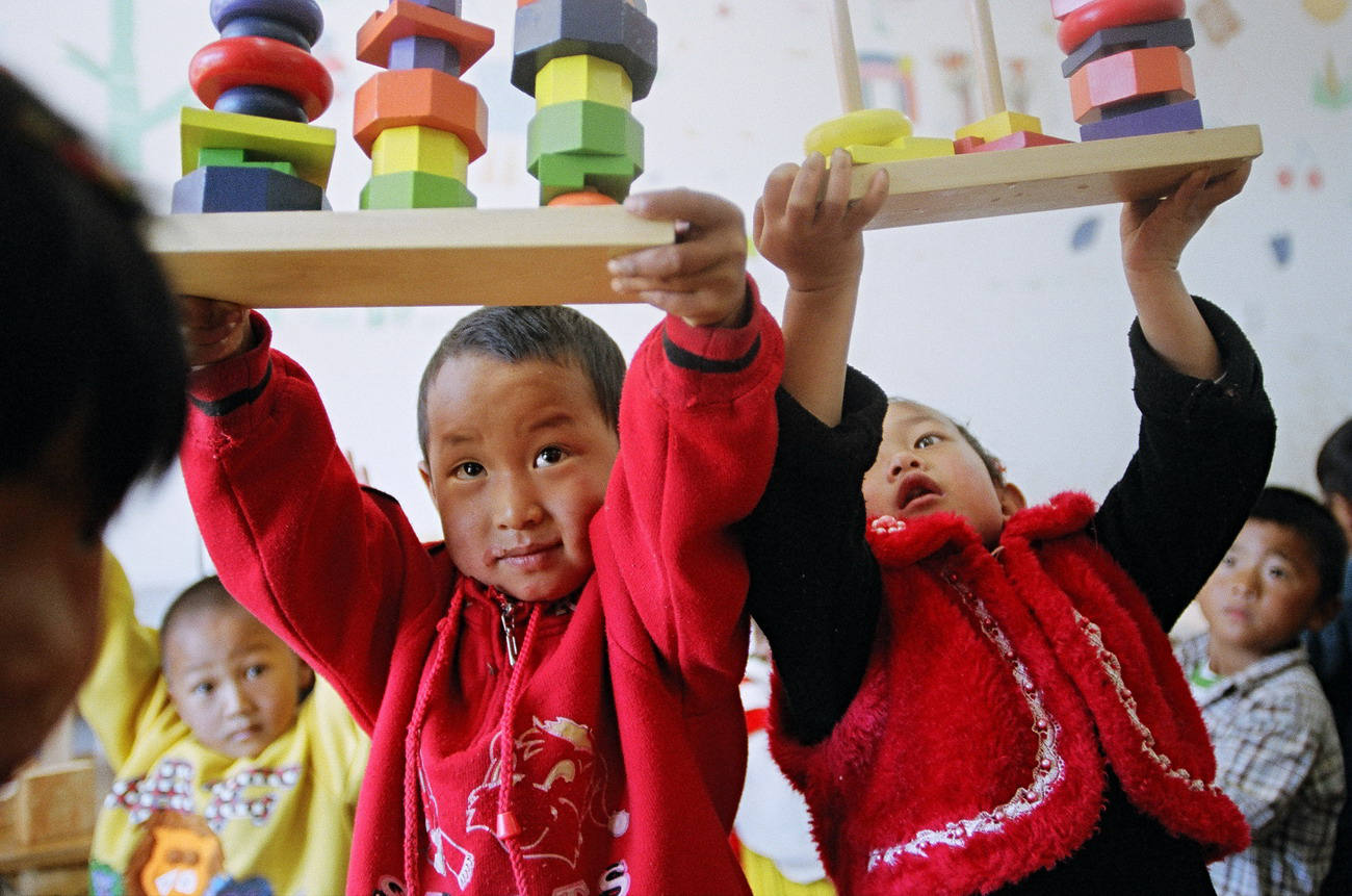 Children with building blocks in a classroom 