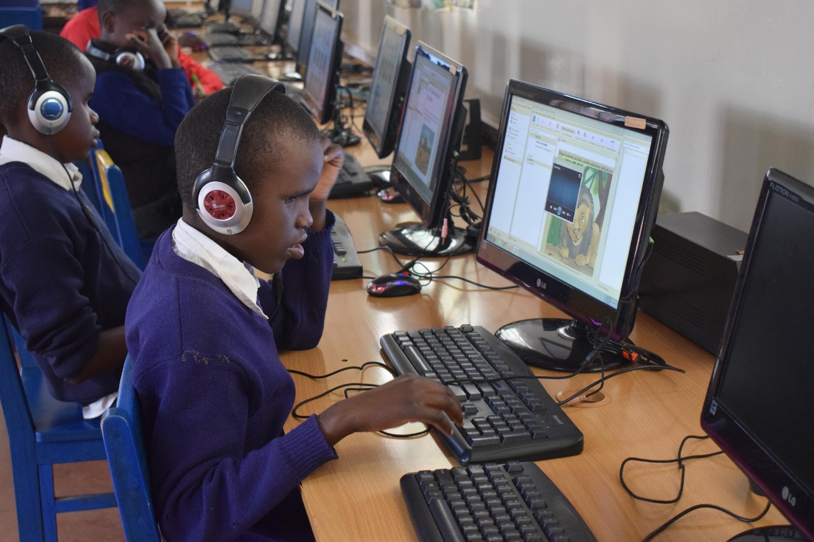 Student at Thika Primary School for the Visually Impaired in Kenya reading accessible storybooks using eKitabu’s e-reader app