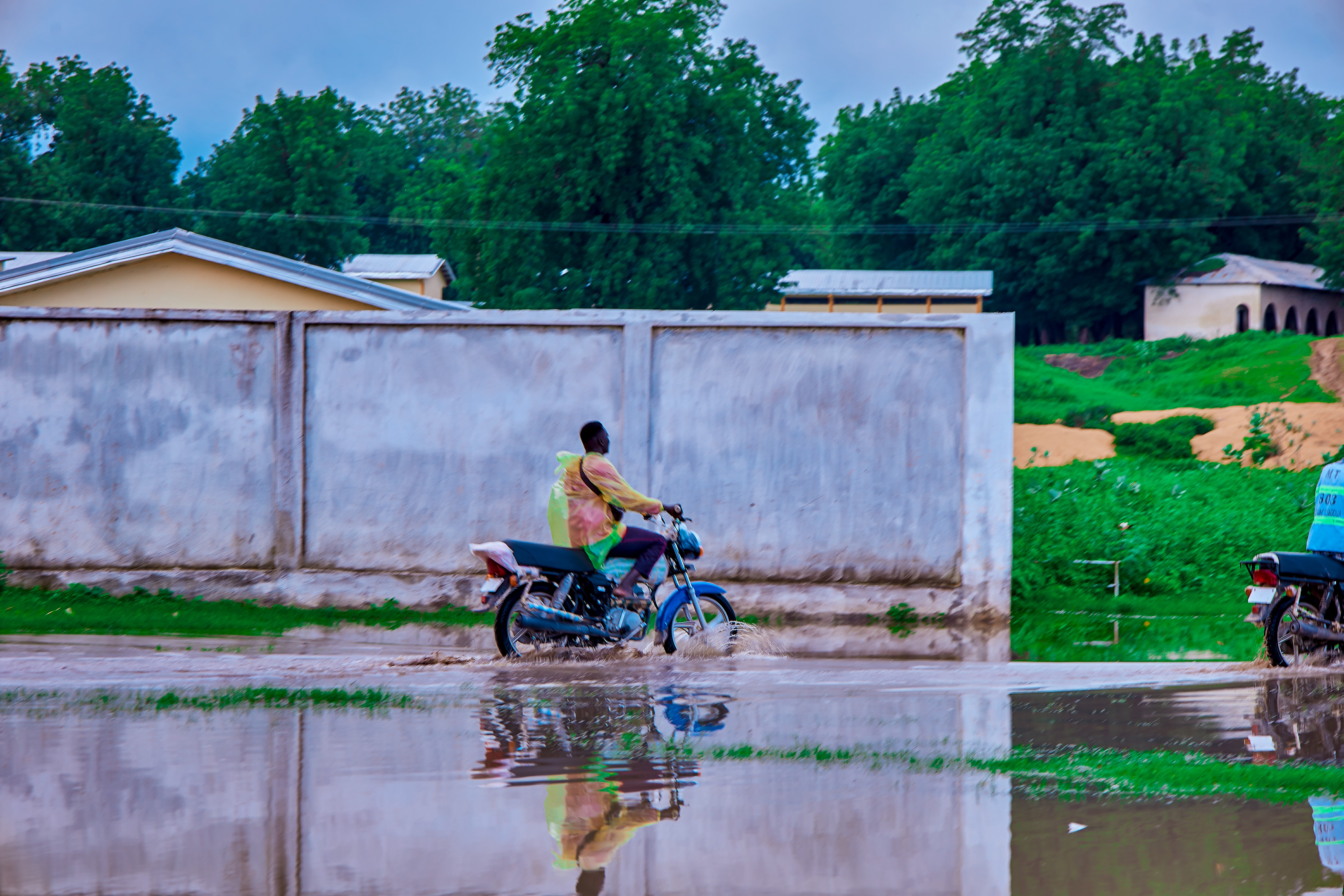 Man rides bicycle in flooded area of Mayo Danay in northern Cameroon