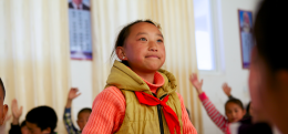 A girl stands out to answer a question at a school which implements Social Emotional Learning method