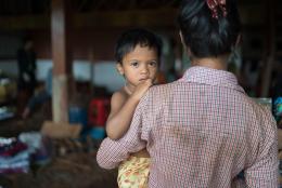 A child being held by a caretaker 