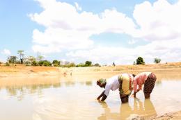 Dorcas Syengo and her neighbour, Jane, fetch water from a dam nearby. Families in this region rely on ground water that has to be purified before it is safe for drinking. They also use it to water their kitchen gardens. 