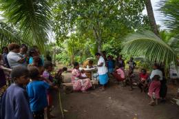 The community gathers around for vaccinations after the drone arrives into Cook’s Bay with the vaccines.