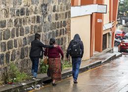 An adolescent reunited with his mother and brother in San Marcos walking to their home. 