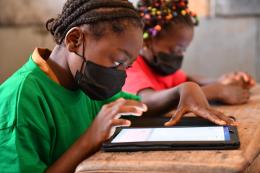 A girl using a tablet in a classroom 