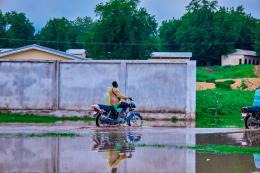 Man rides bicycle in flooded area of Mayo Danay in northern Cameroon